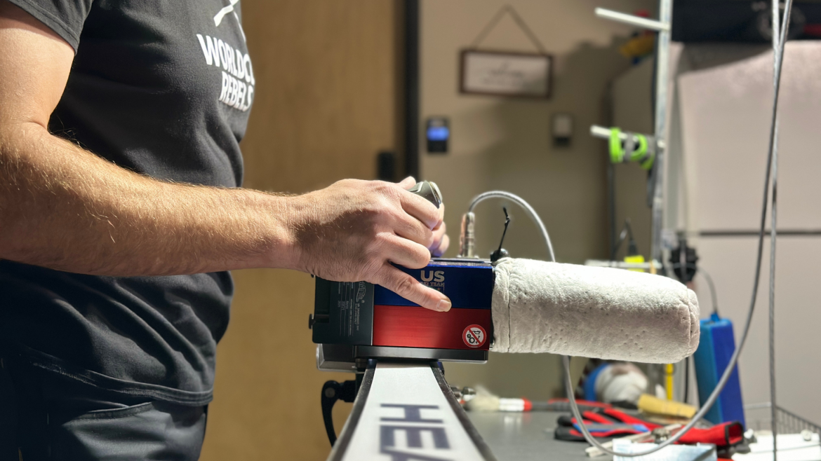 Mike Beers, Race tech Service ski serviceman, using Ratte handheld side edger on a pair of Head race skis